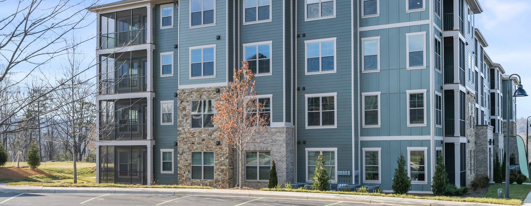 a multi-story building with a parking lot