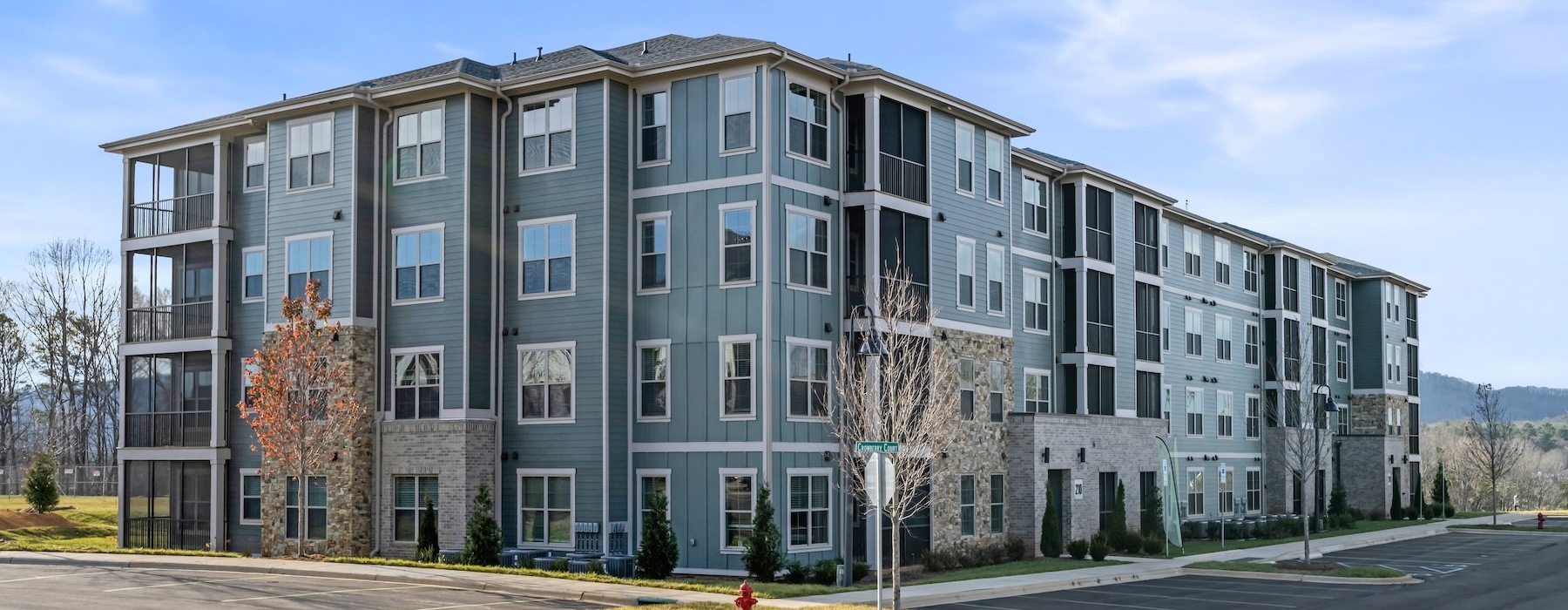 a multi-story building with a parking lot