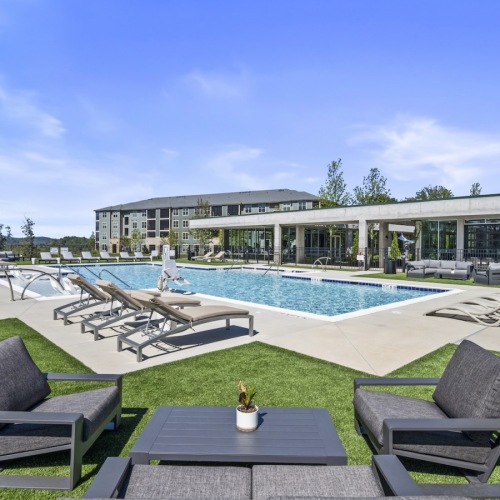 Resort-style swimming pool with lounge seating
